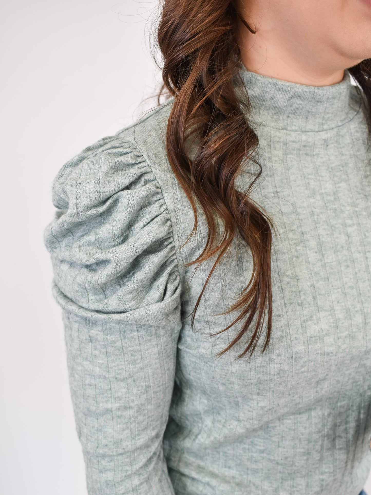 A green puff shoulder long sleeve ribbed style top