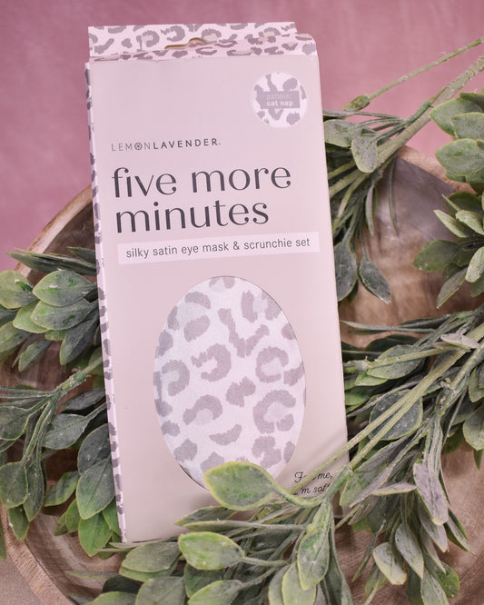 Silky satin eye mask and scrunchie set packaging with leopard print design on a pink background.