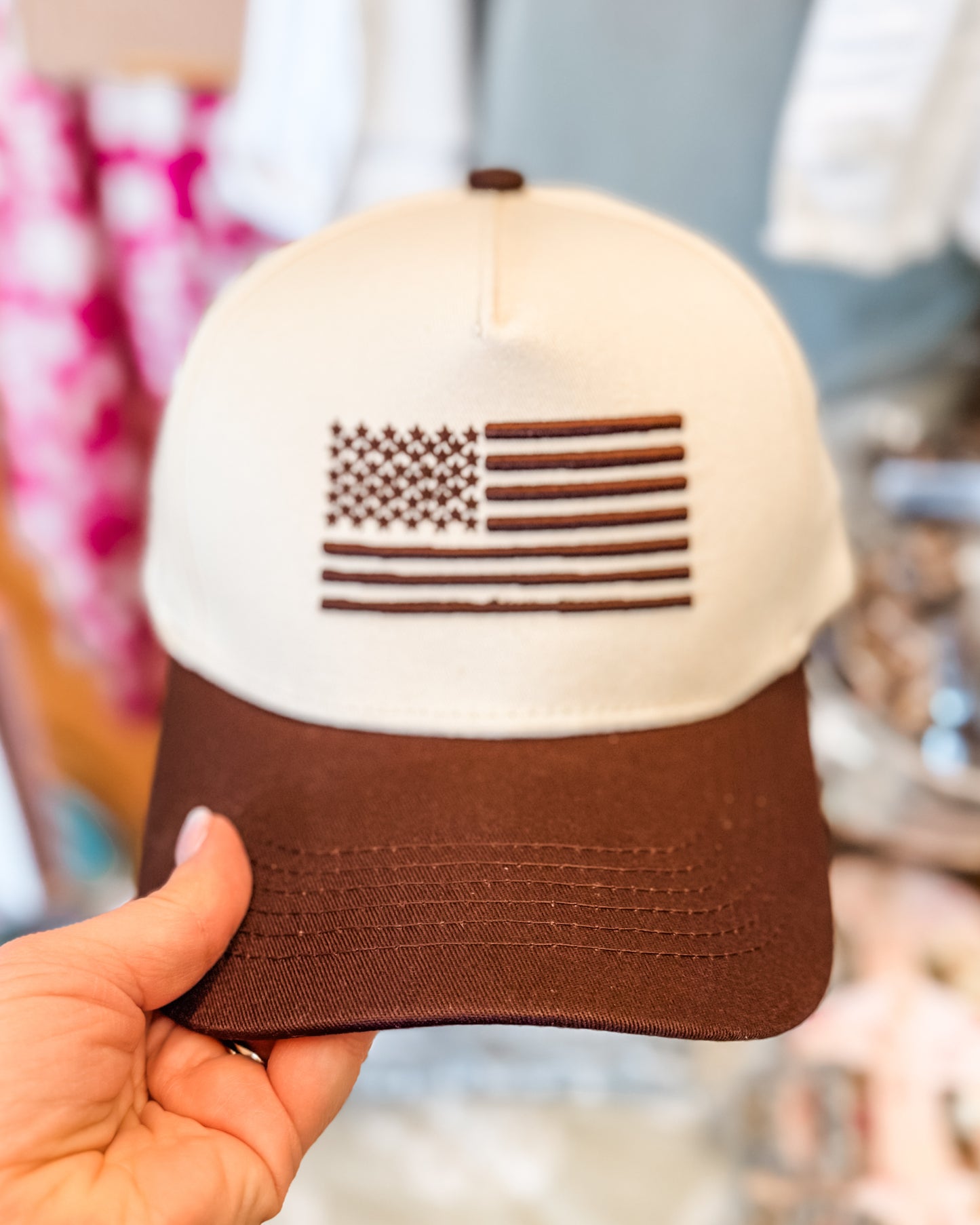 Neutral tone brown and cream hat with embroidered flag