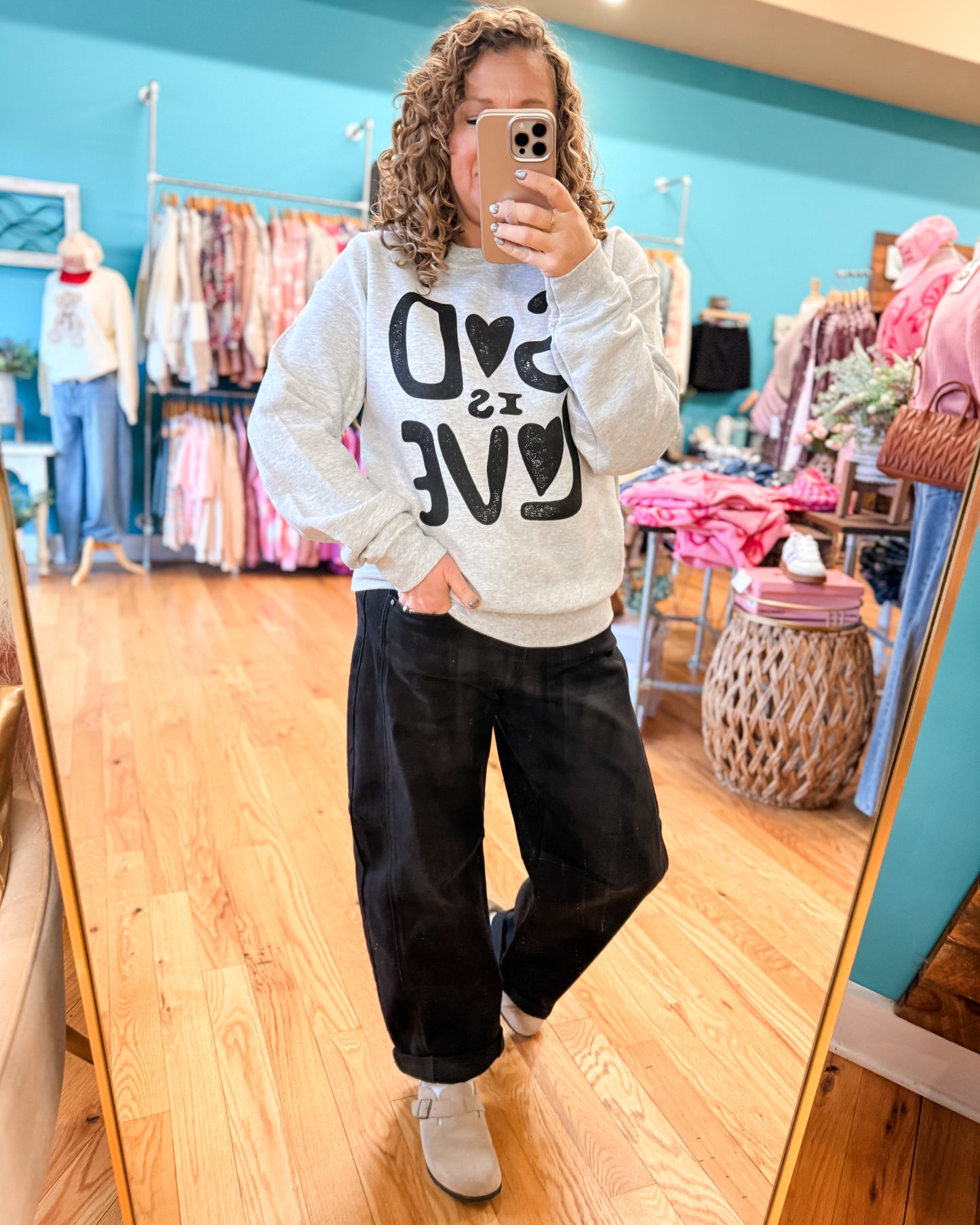 Person wearing a sweatshirt with text in a store setting