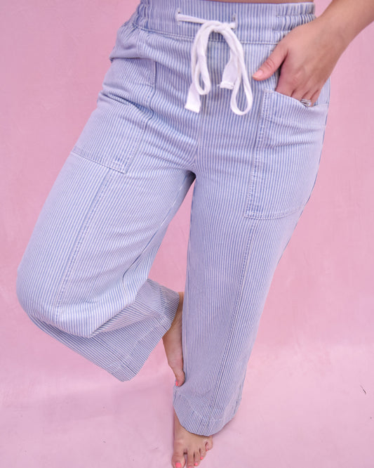 Light blue striped pants with a drawstring on a pink background
