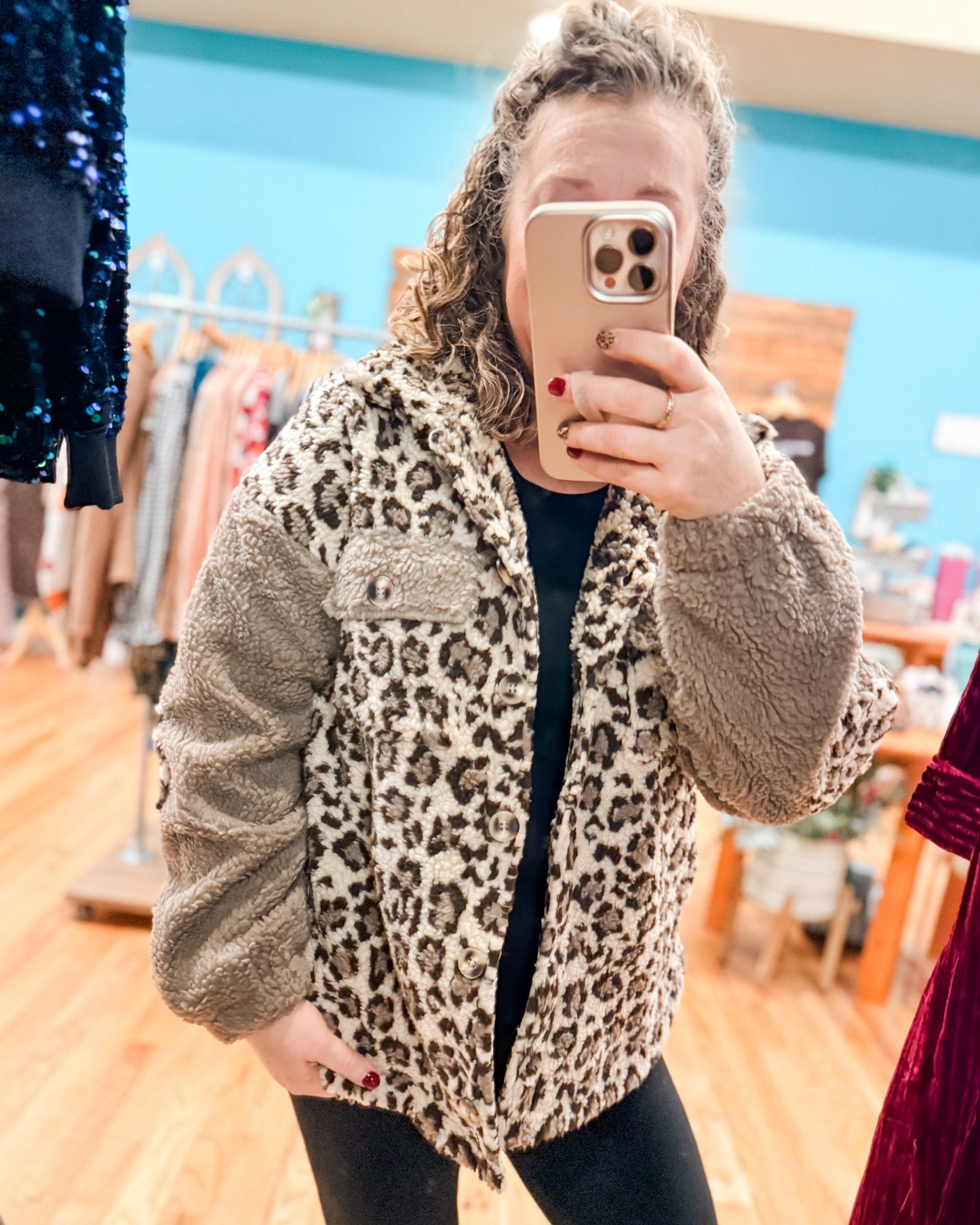 Person wearing a leopard print jacket in a store setting