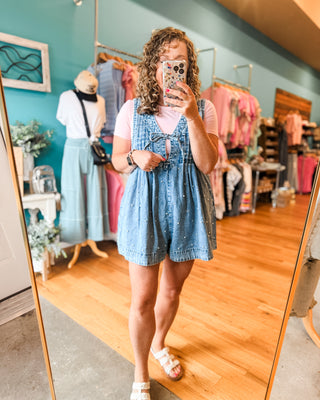 a pearl denim jumper paired with a basic bodysuit