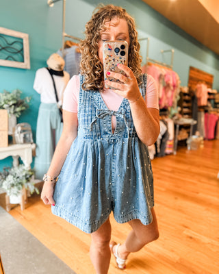 a pearl denim jumper paired with a basic bodysuit