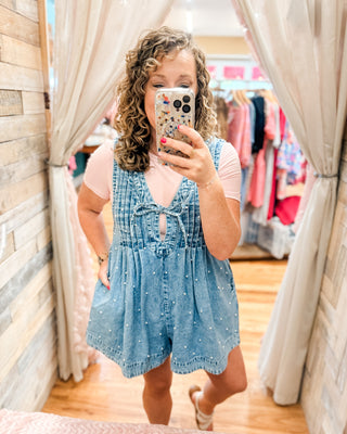 a pearl denim jumper paired with a basic bodysuit