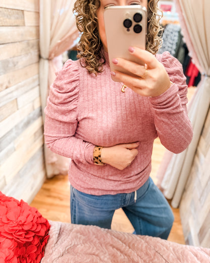 A pink puff sleeve long sleeve ribbed style top