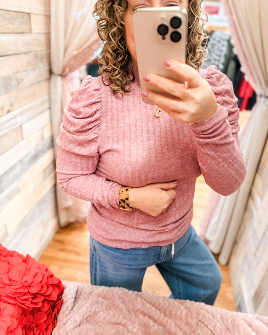 A pink puff sleeve long sleeve ribbed style top
