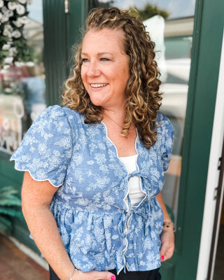 a denim floral embroidered peplum top