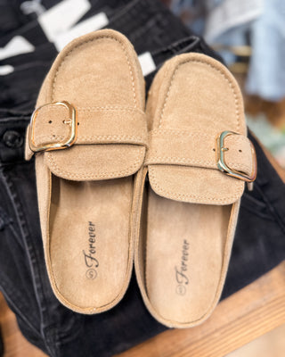 a suede slip on mule style shoe with buckle and side studs
