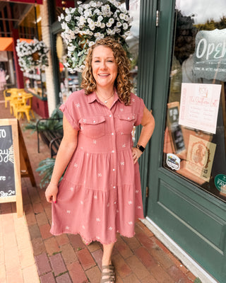 A rose colored button down tiered bow embroidered dress with front flap pockets