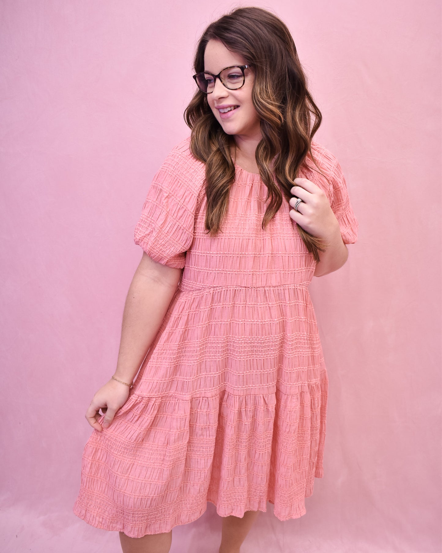 a textured knee length dress in a spring coral color