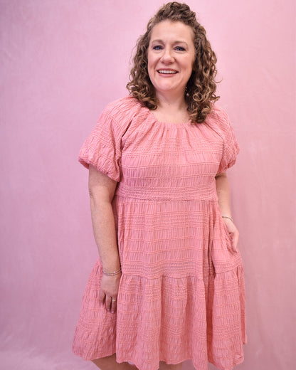 a textured knee length dress in a spring coral color