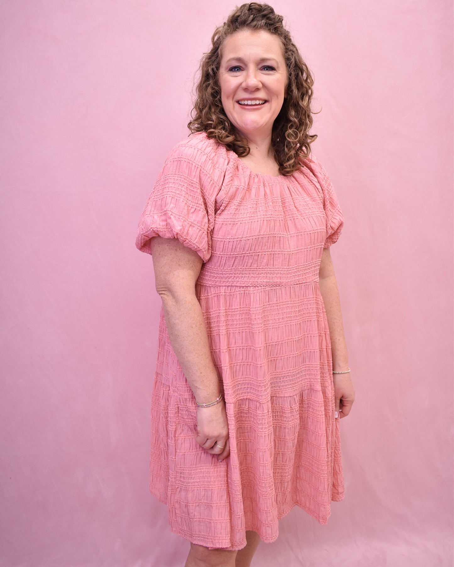 a textured knee length dress in a spring coral color