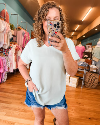 a vneck matte style top with rolled sleeves