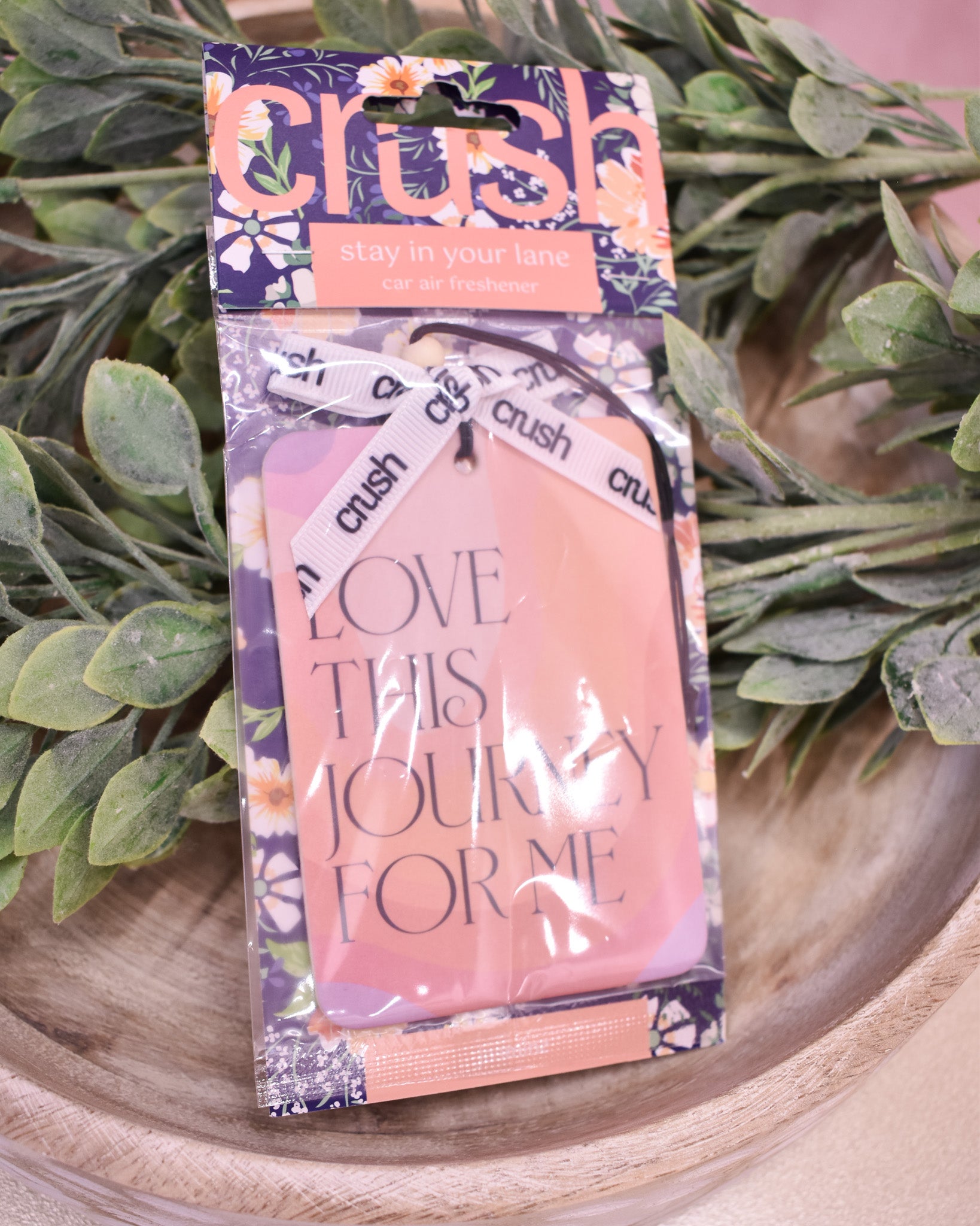 Packaged product with 'crush' branding and text on a wooden surface with greenery