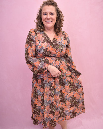 Woman wearing a floral dress against a pink background
