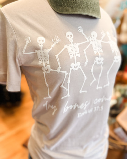 Gray t-shirt with skeleton design and text on a blurred background