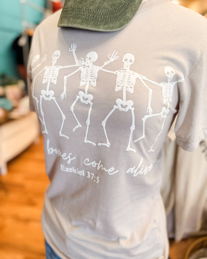 Gray t-shirt with skeleton design and text on a blurred background