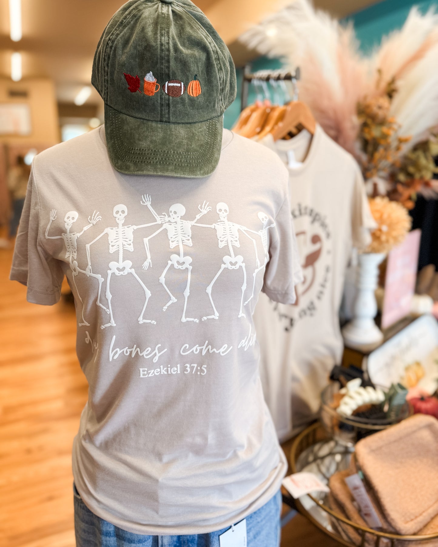 T-shirt with skeleton design and cap in a store setting
