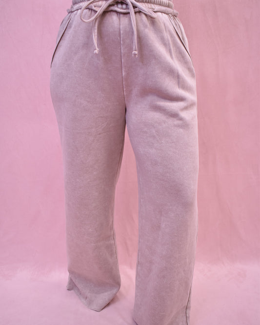 Light gray sweatpants on a pink background