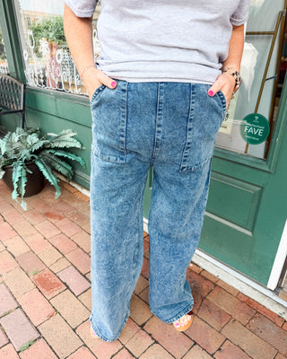 a pair of high waisted wide leg jeans in a dark mineral wash