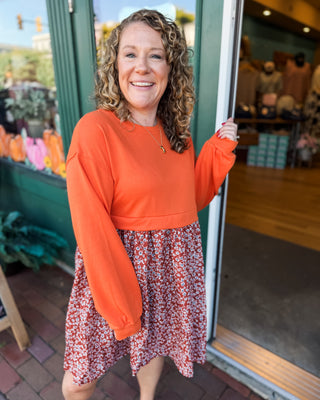 a solid sweatshirt style top with flowy skirt mini dress with floral pattern