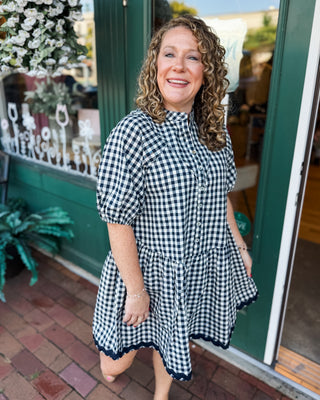 a short sleeve drop hem navy gingham dress with button down front and ric rac hem details
