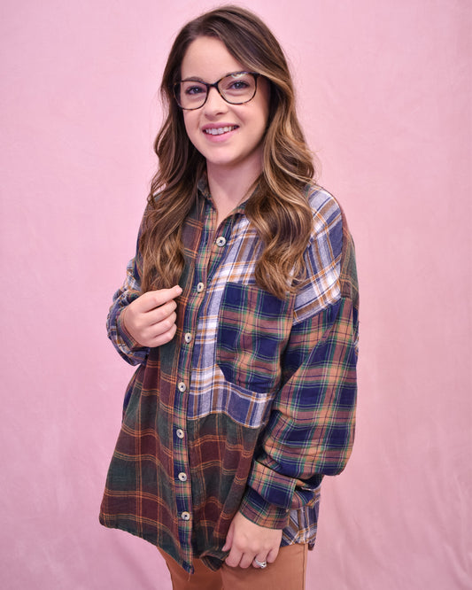 Woman wearing a plaid shirt against a pink background