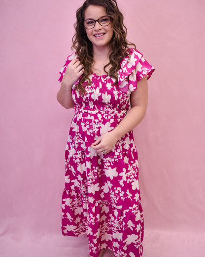 Ruffle sleeve midi dress with floral details in white, and ruching across the bust.