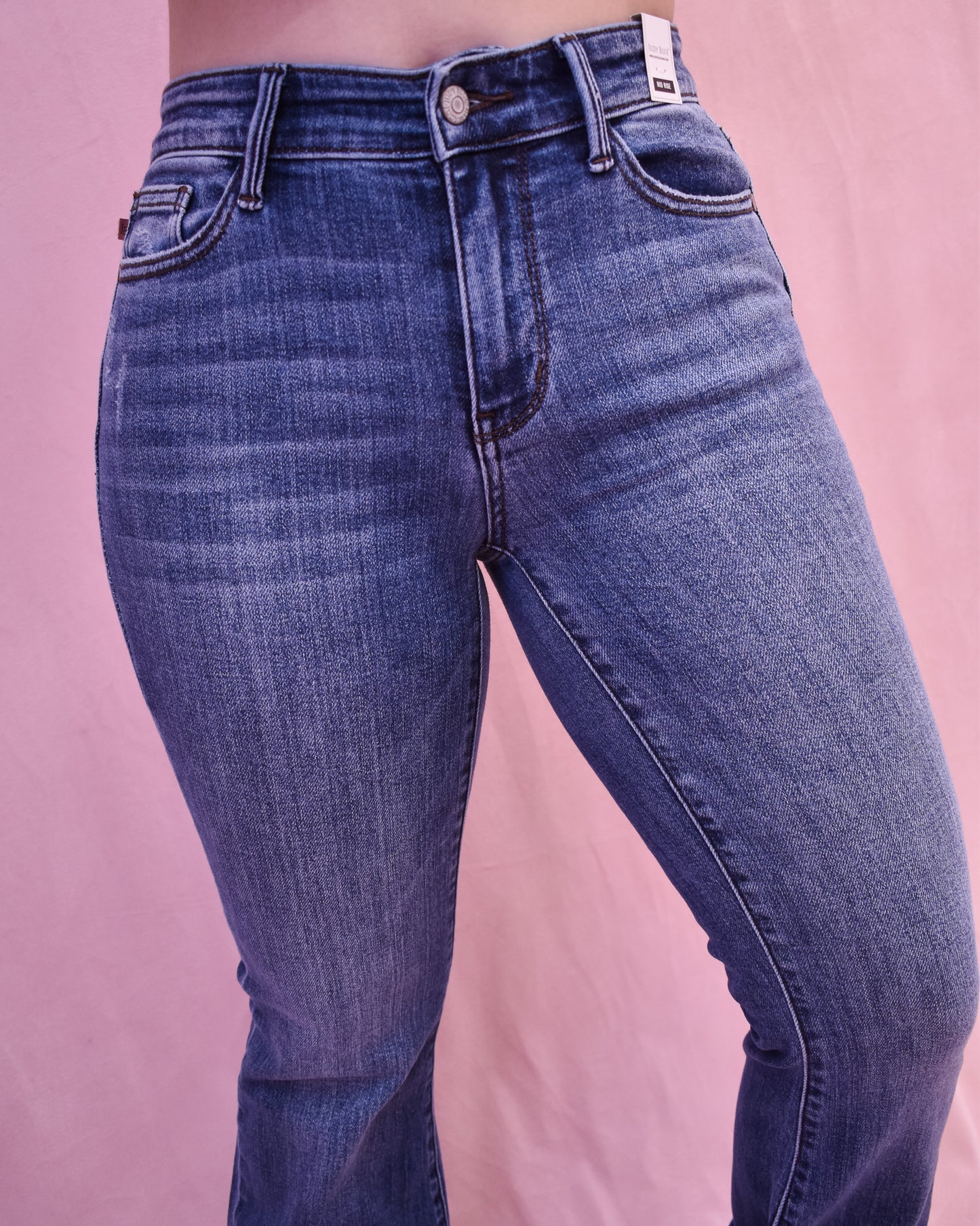 Blue jeans on a pink background