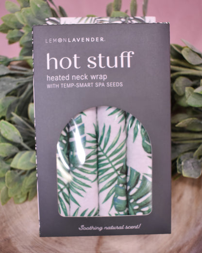Lemon Lavender heated neck wrap packaging with palm leaf design on a wooden surface.