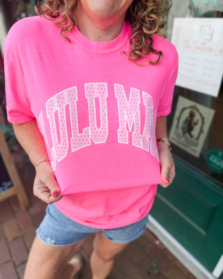A graphic tee in neon pink with LULU MAC graphic in light pink and polka dots
