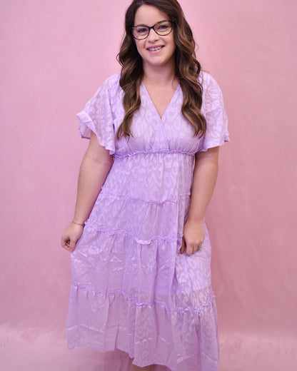 a light lavender tiered dress with an embossed leopard print