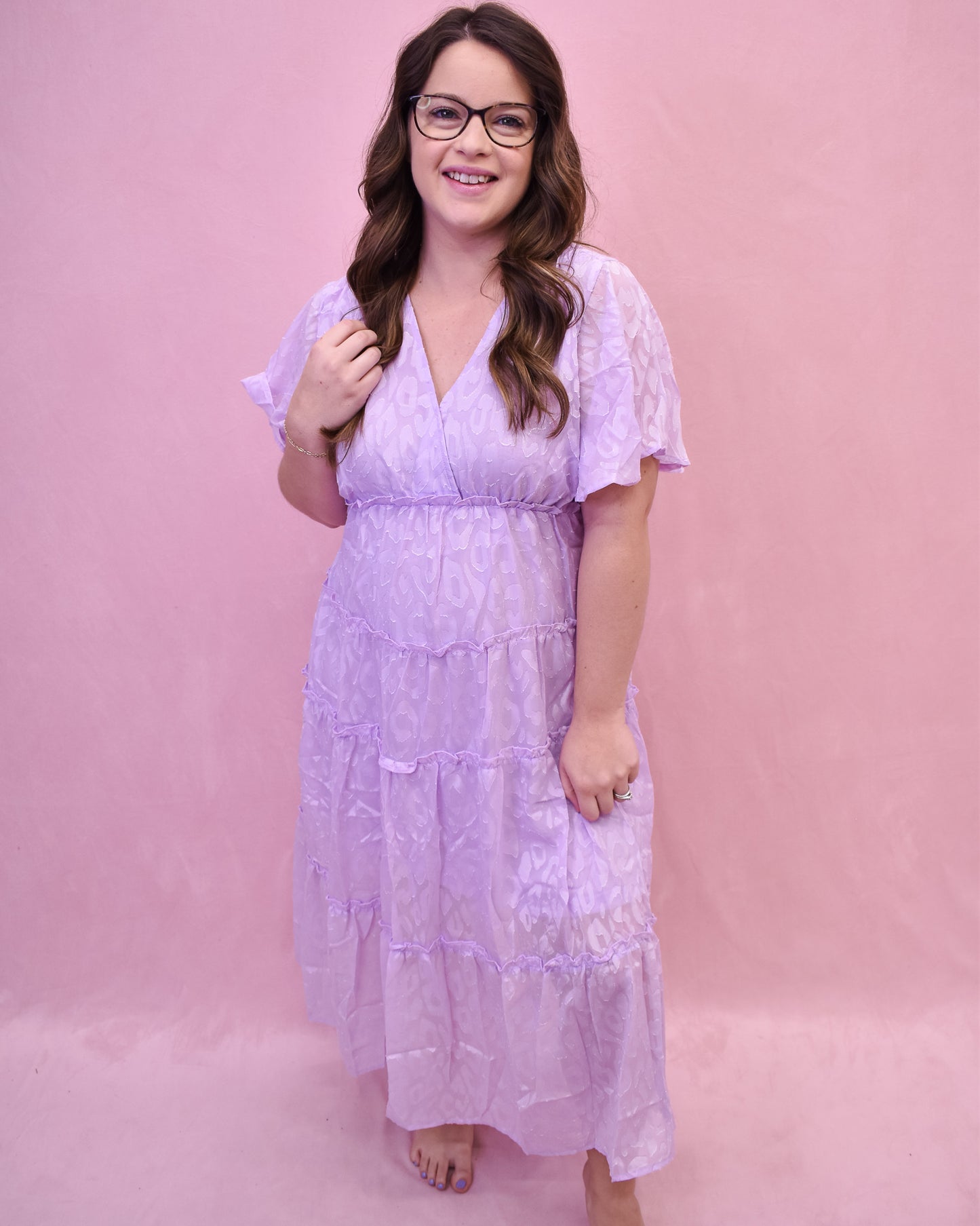 a light lavender tiered dress with an embossed leopard print