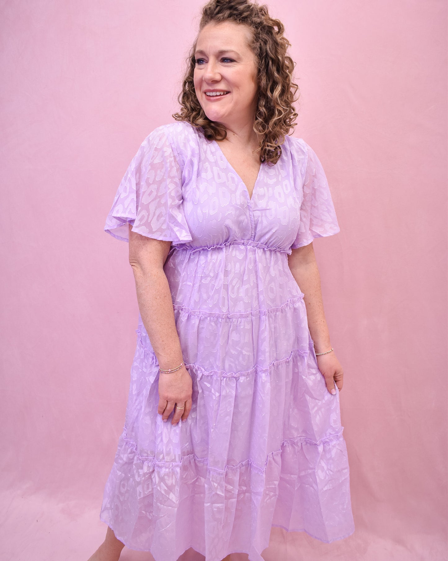 a light lavender tiered dress with an embossed leopard print