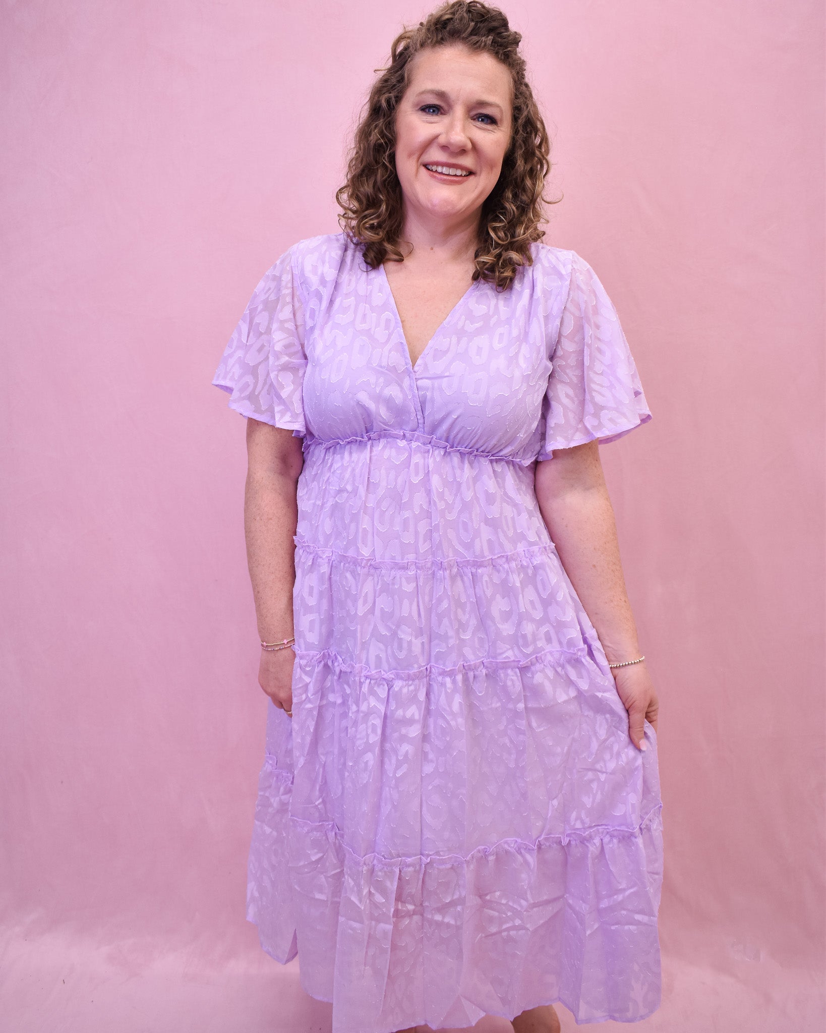 a light lavender tiered dress with an embossed leopard print