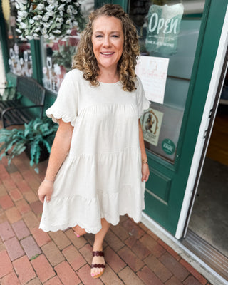 a scalloped linen tiered knee length baby doll dress