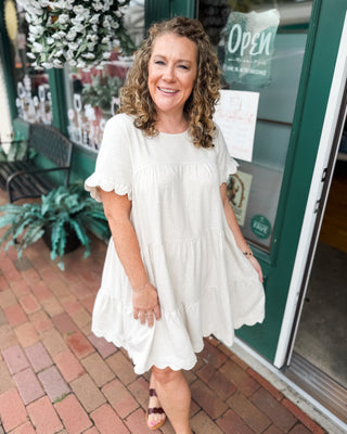 a scalloped linen tiered knee length baby doll dress