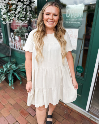 a scalloped linen tiered knee length baby doll dress