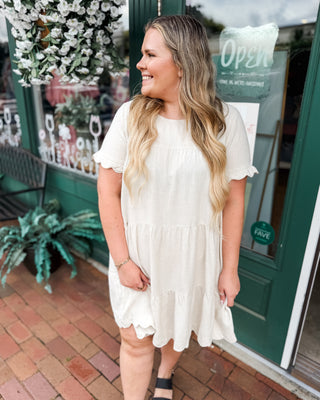 a scalloped linen tiered knee length baby doll dress