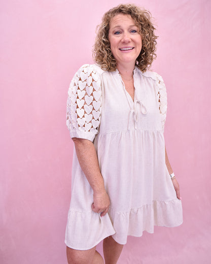 Tiered linen style dress with heart crochet puff sleeves.