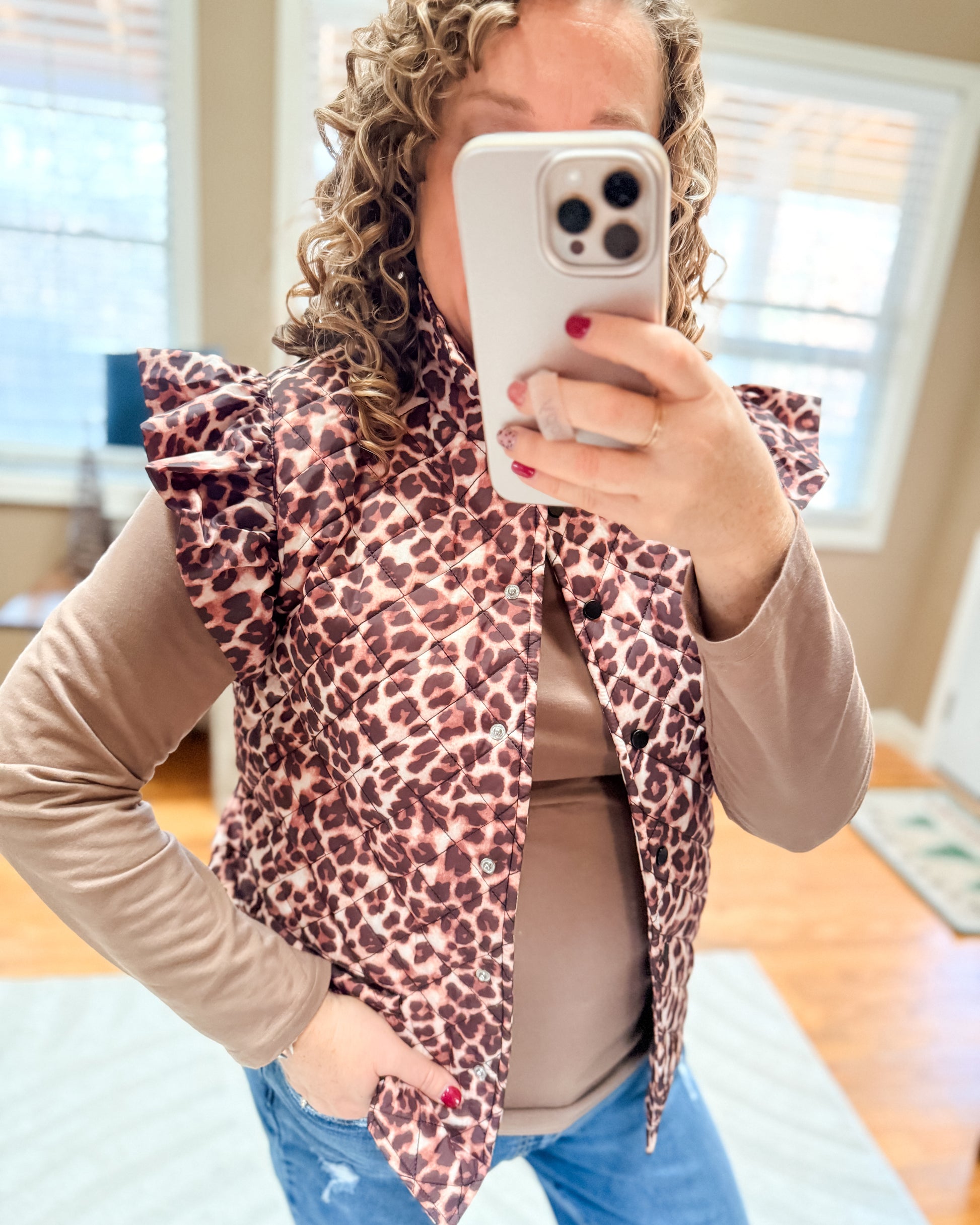 Person wearing a leopard print vest indoors