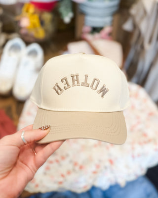 a canvas snapback hat with MOTHER upside down embroidered