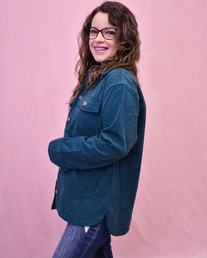 Person wearing a blue jacket against a pink background