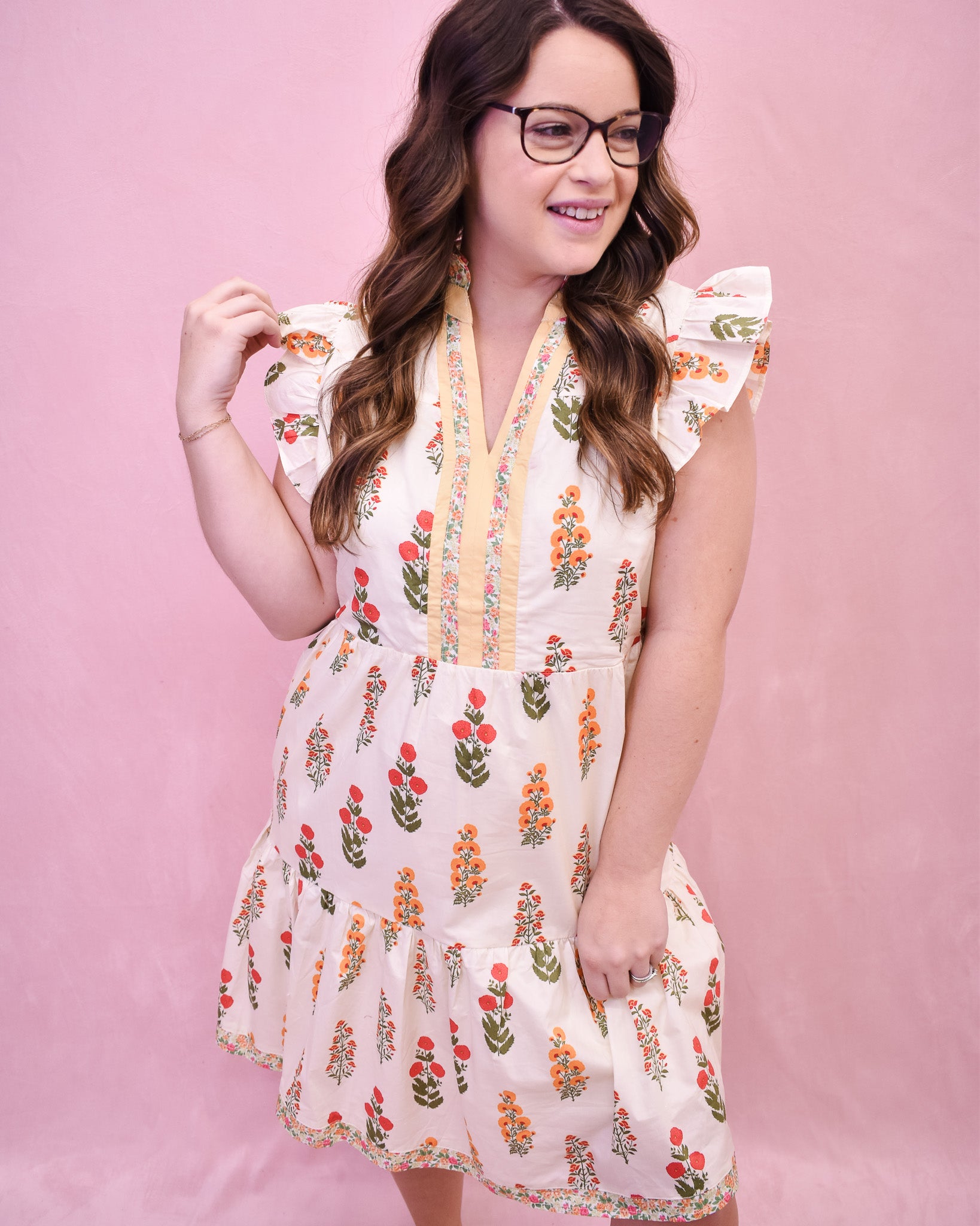 Cream colored floral mini dress with flutter sleeves