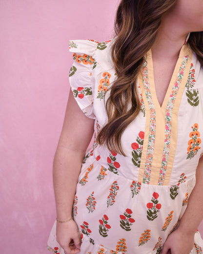 Cream colored floral mini dress with flutter sleeves