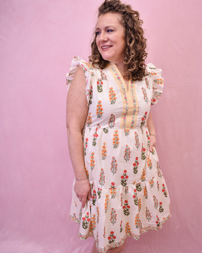 Cream colored floral mini dress with flutter sleeves