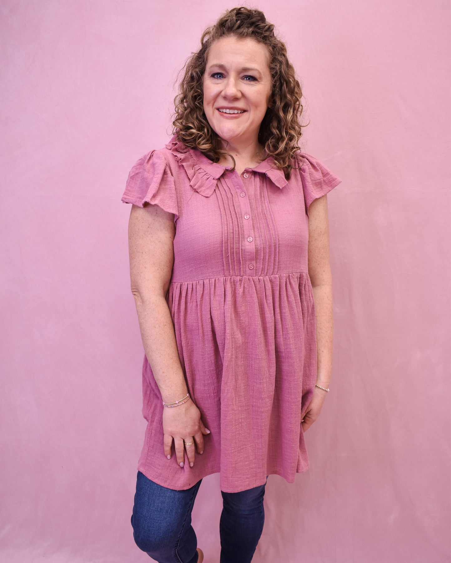 a mauve linen mini dress with front pleated style and collar.