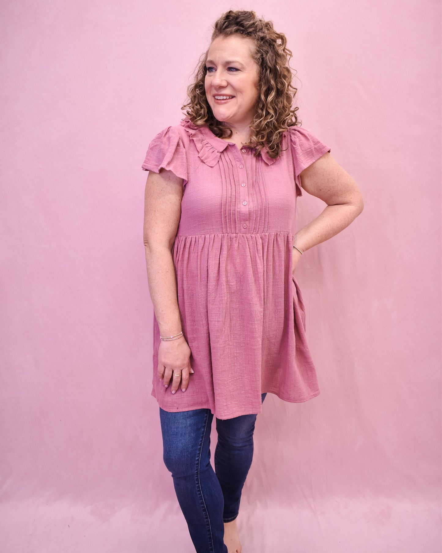 a mauve linen mini dress with front pleated style and collar.