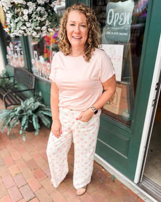 white casual style pants with pink polka dots